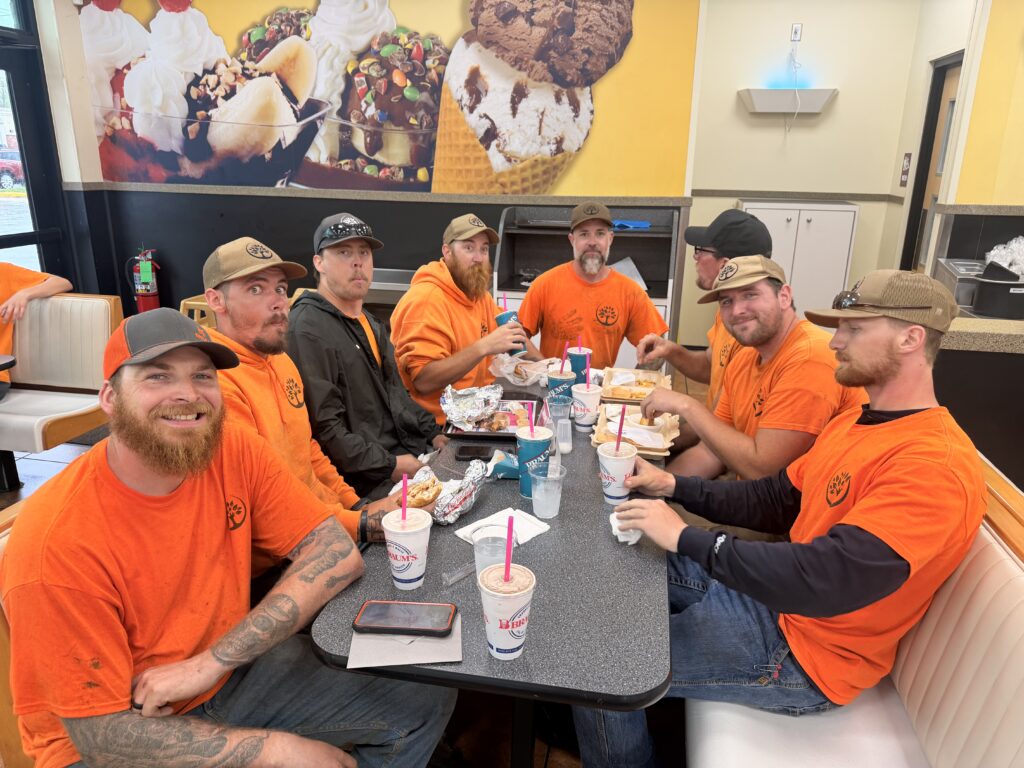 Trufast crew sharing a reward for 20 signs placed at satisfied customers' houses