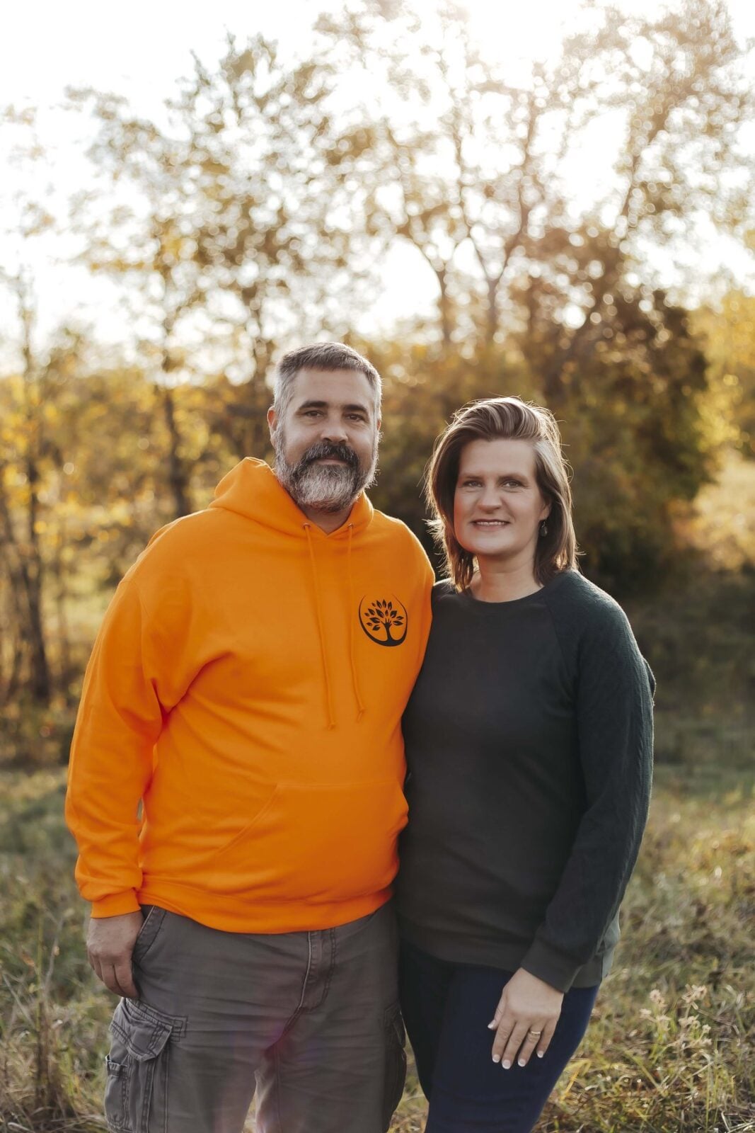Owner Kyle Theobald in an orange Trufast hoodie standing with Linn